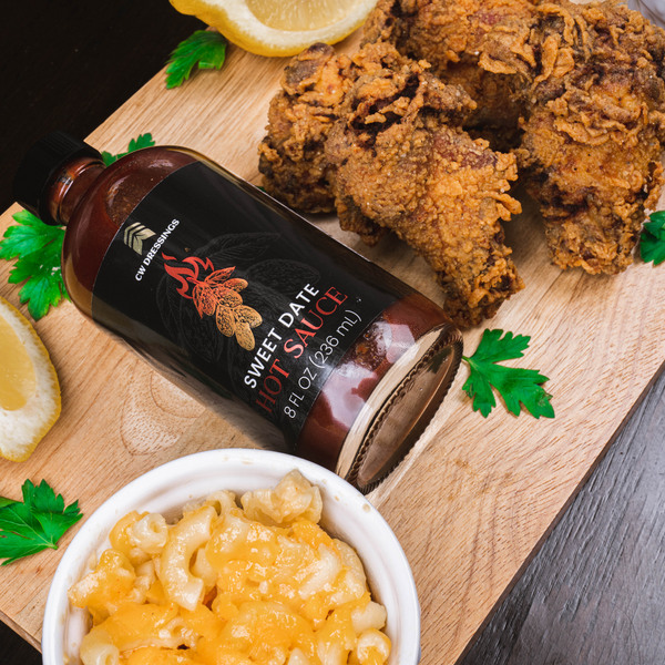 CW Dressings Sweet Date Hot Sauce; Date Hot Sauce made with 100% organic deglet nour date syrup served with fried chicken & macaroni and cheese